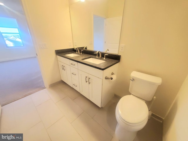 bathroom featuring tile patterned flooring, vanity, and toilet