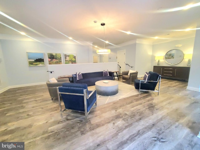 living room with hardwood / wood-style floors and ornamental molding