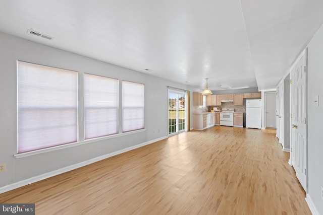 unfurnished living room with light wood-type flooring