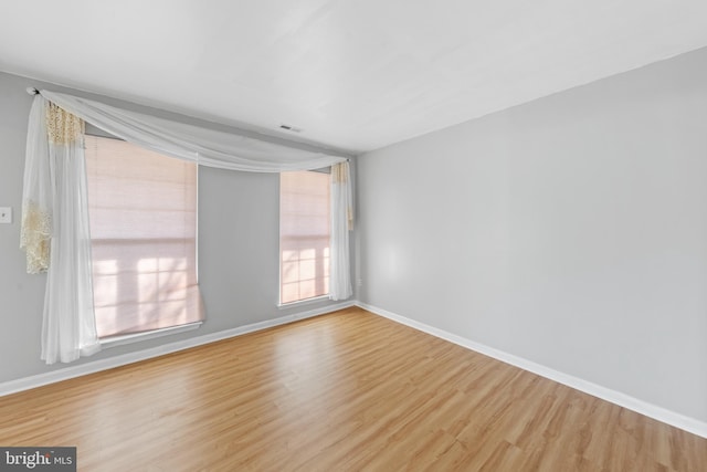 spare room with hardwood / wood-style flooring