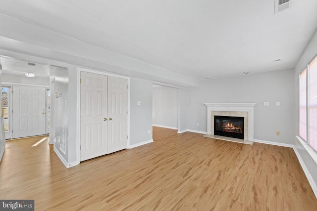 unfurnished living room with light wood-type flooring