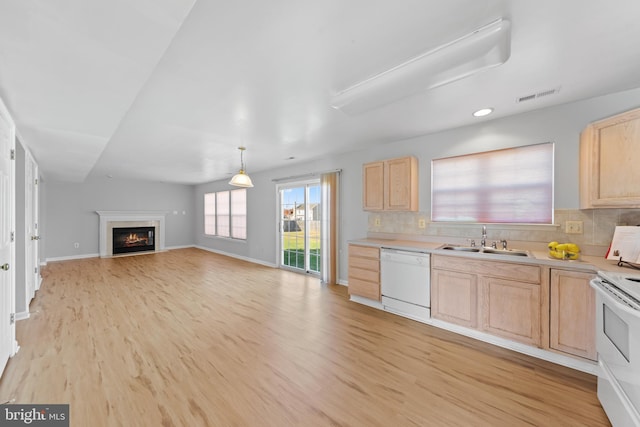 kitchen featuring light brown cabinetry, tasteful backsplash, white appliances, sink, and light hardwood / wood-style flooring