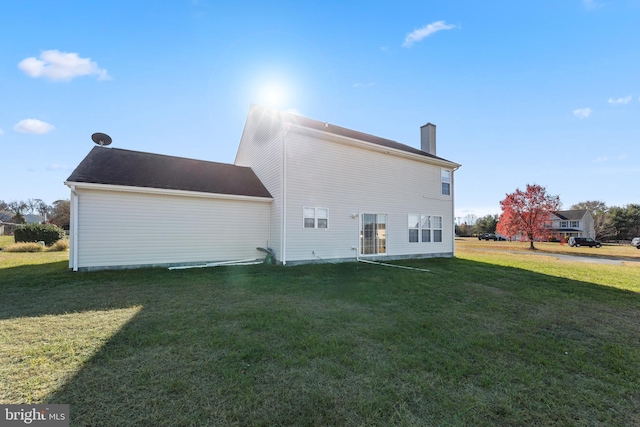 back of house featuring a yard