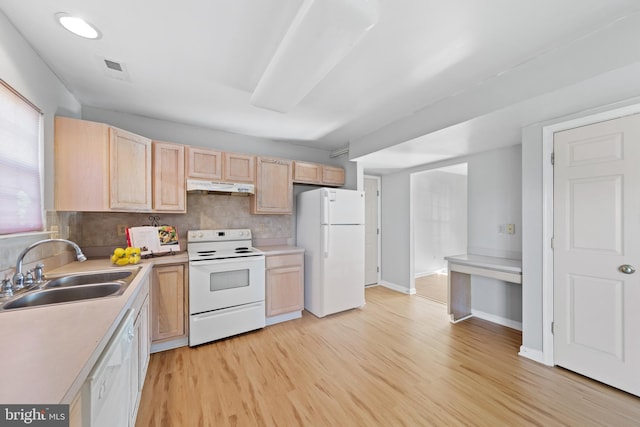 kitchen featuring sink, light hardwood / wood-style flooring, backsplash, white appliances, and light brown cabinetry