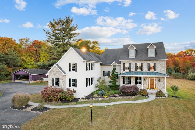 view of front of house featuring a front yard, a porch, and a carport