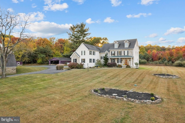 view of front of house with a front yard and a garage