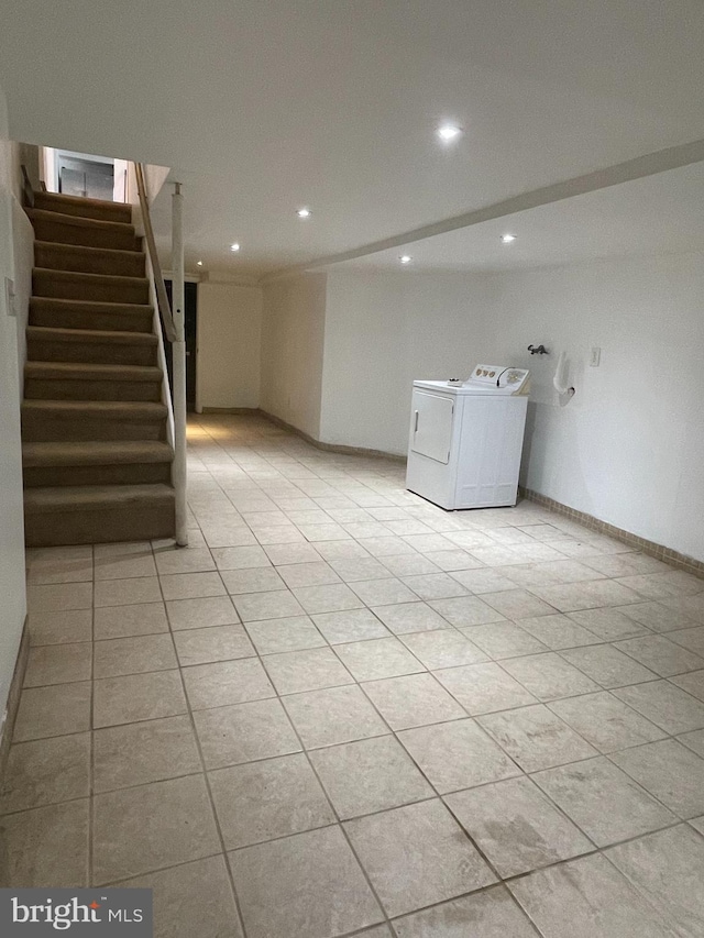 clothes washing area featuring washing machine and dryer and light tile patterned floors