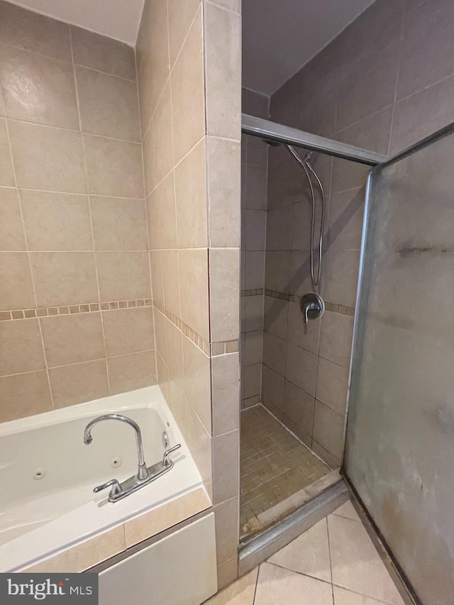 bathroom featuring shower with separate bathtub and tile patterned flooring