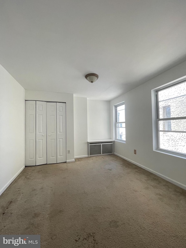 unfurnished bedroom with a closet and carpet floors