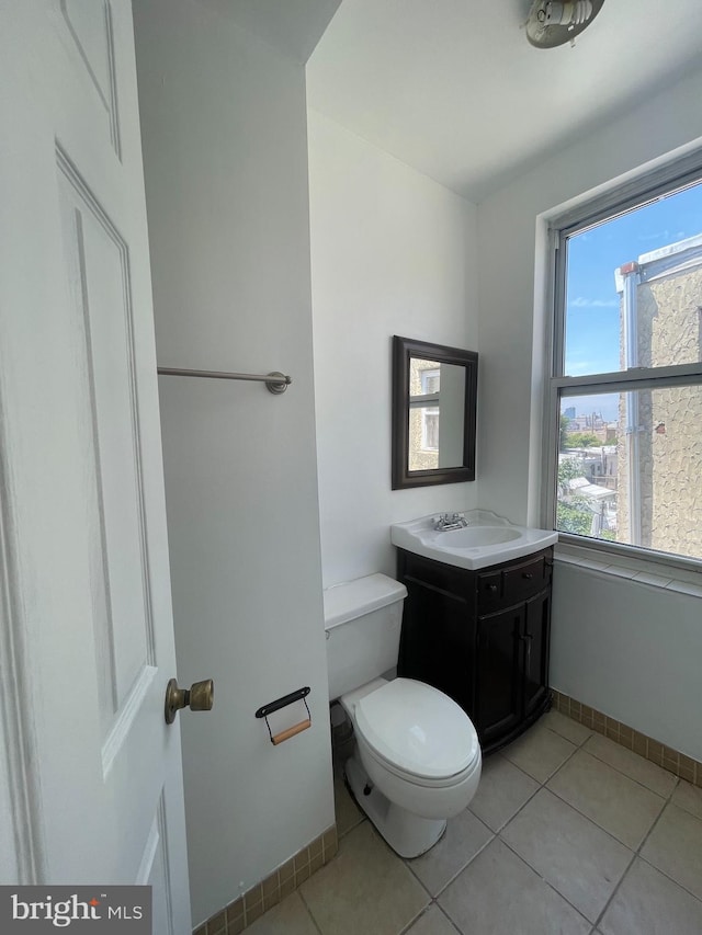 bathroom featuring vanity, toilet, and tile patterned flooring