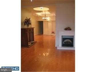 hallway with hardwood / wood-style floors