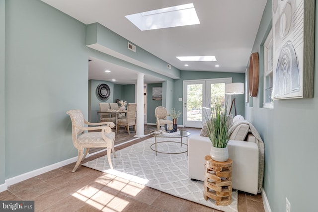 living room featuring lofted ceiling, french doors, and light tile patterned floors