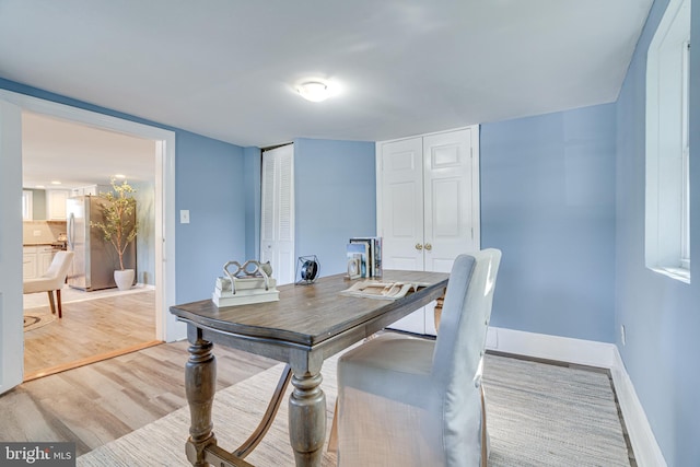 dining space with light hardwood / wood-style flooring