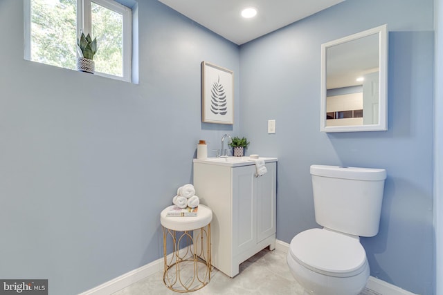 bathroom with vanity, toilet, and tile patterned floors