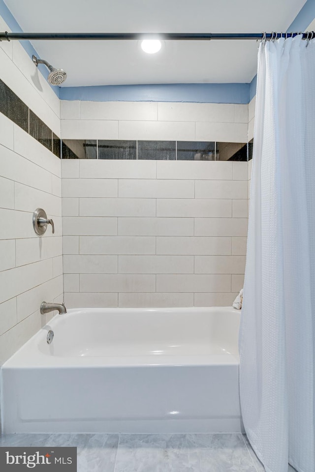 bathroom featuring shower / tub combo with curtain