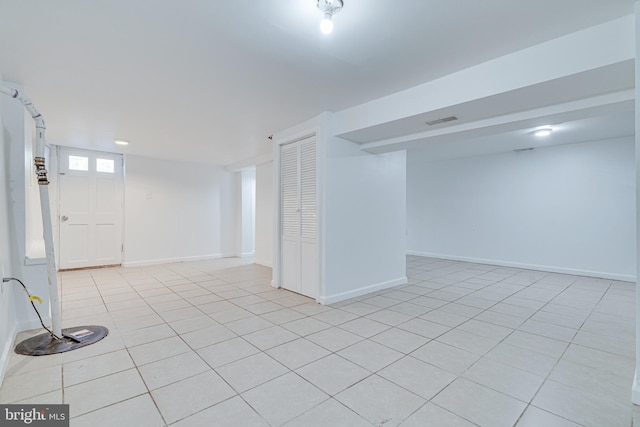 basement featuring light tile patterned floors