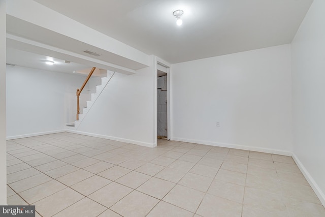 basement featuring light tile patterned flooring