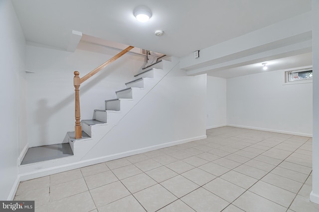 basement featuring light tile patterned floors