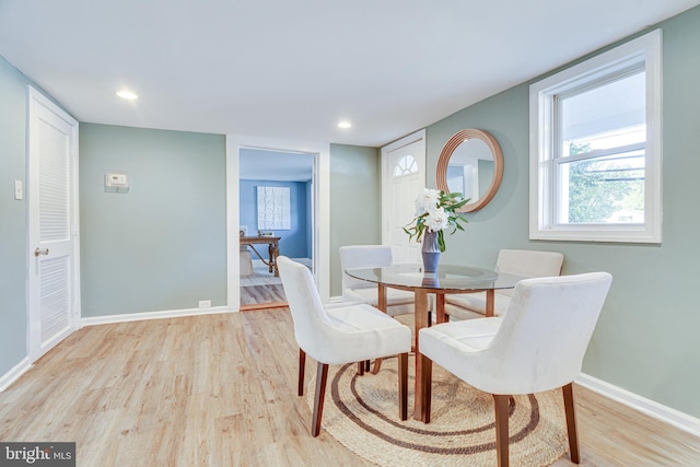 dining space with light hardwood / wood-style flooring