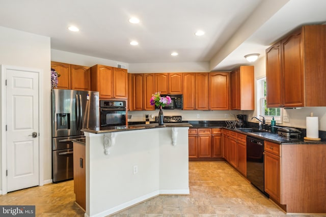 kitchen with black appliances, sink, dark stone counters, and a kitchen island