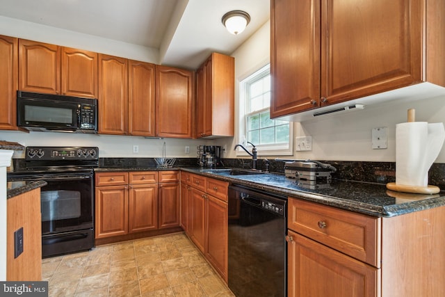 kitchen with sink, black appliances, and dark stone counters