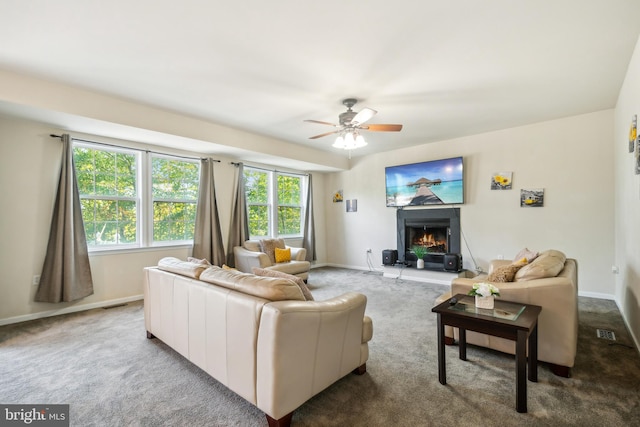 living room with ceiling fan and carpet flooring