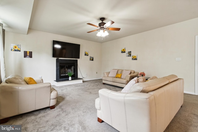 carpeted living room with ceiling fan