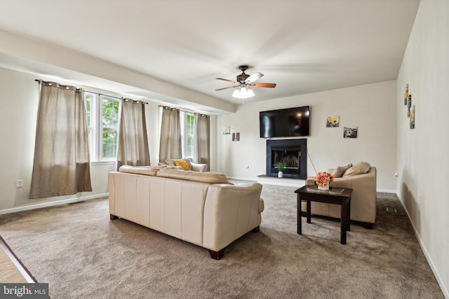 carpeted living room with ceiling fan