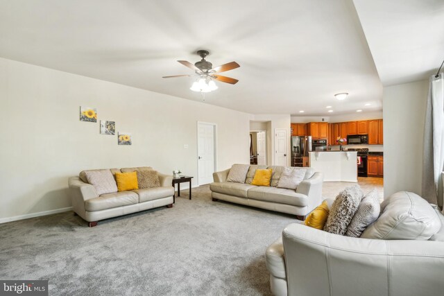 living room with ceiling fan and light colored carpet