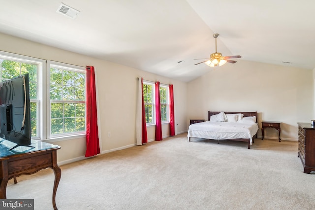 bedroom with light carpet, multiple windows, lofted ceiling, and ceiling fan