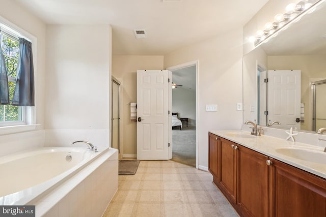 bathroom with vanity, ceiling fan, a wealth of natural light, and shower with separate bathtub