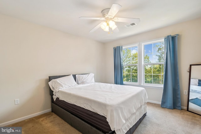 bedroom with light colored carpet and ceiling fan