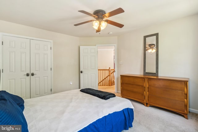 carpeted bedroom with a closet and ceiling fan