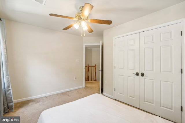 bedroom featuring light carpet, a closet, and ceiling fan