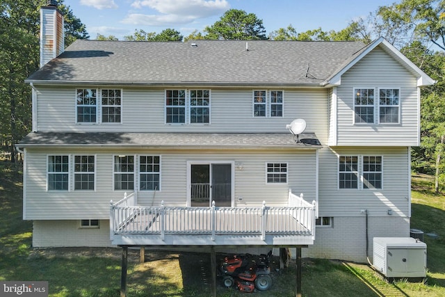 back of house featuring a yard and a deck