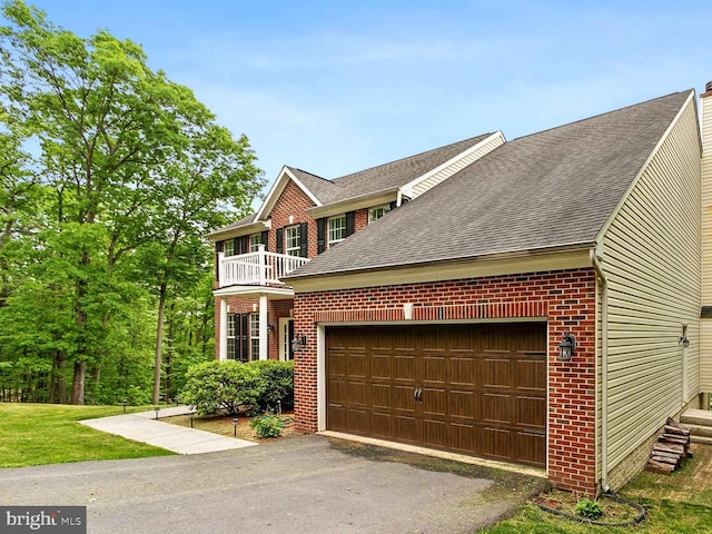 view of front facade with a balcony and a garage