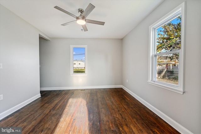 empty room featuring dark wood-type flooring and ceiling fan