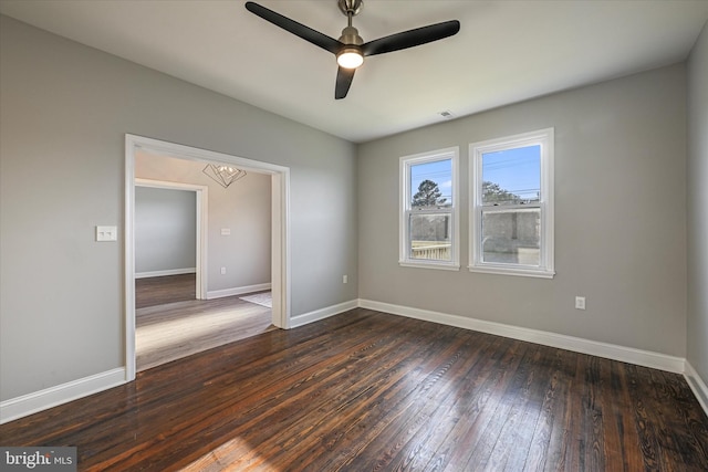 empty room featuring dark hardwood / wood-style floors and ceiling fan