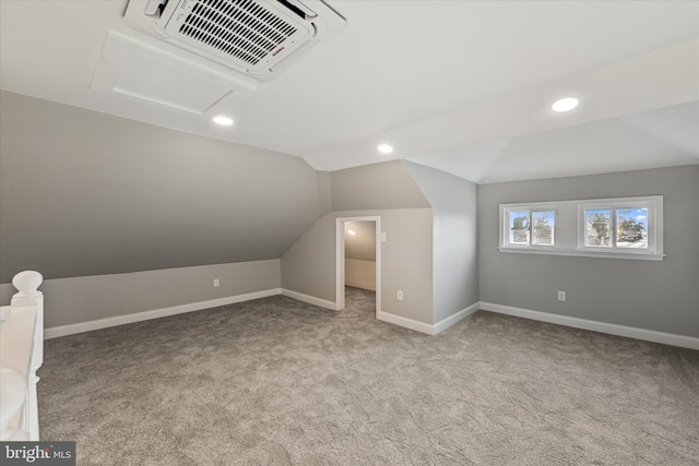 additional living space with light carpet and vaulted ceiling