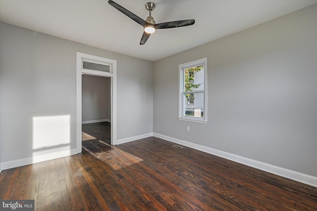 empty room with dark wood-type flooring and ceiling fan