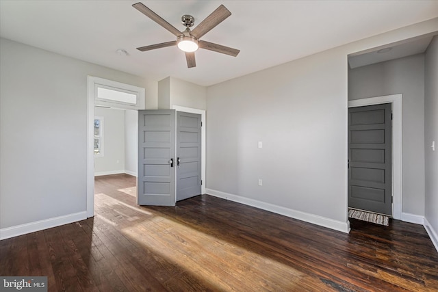 unfurnished bedroom with ceiling fan and dark hardwood / wood-style flooring