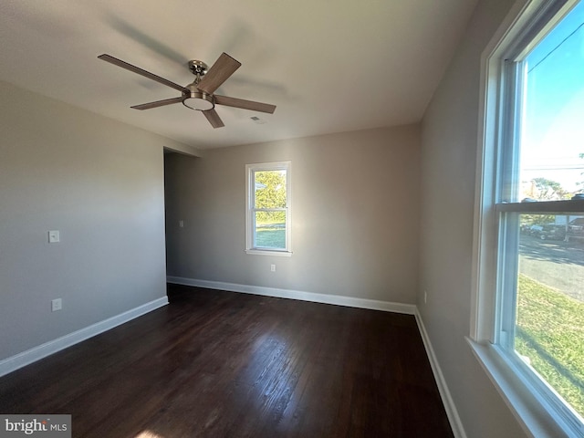 spare room with ceiling fan and dark hardwood / wood-style flooring