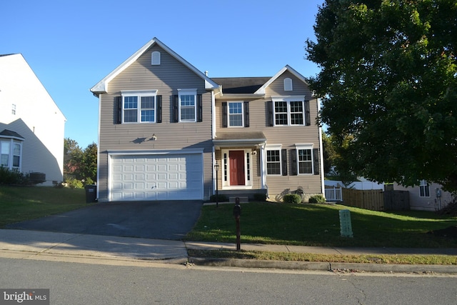 view of front of property featuring a front yard and a garage