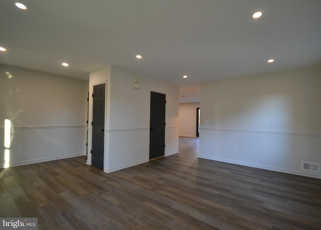 unfurnished room with dark hardwood / wood-style flooring