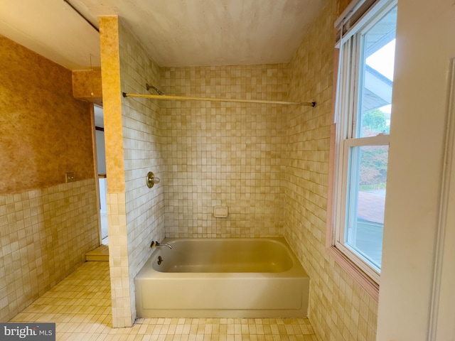 bathroom featuring tile walls, shower with separate bathtub, a healthy amount of sunlight, and tile patterned floors