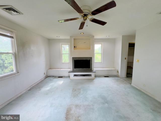 unfurnished living room with ceiling fan