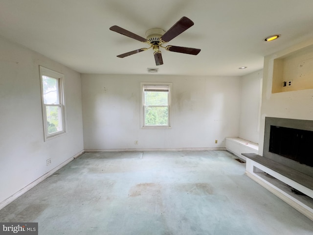 unfurnished living room featuring radiator heating unit and ceiling fan