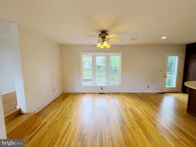 spare room featuring light hardwood / wood-style flooring and ceiling fan