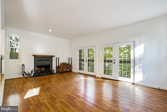 unfurnished living room featuring french doors and wood-type flooring