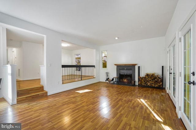 unfurnished living room with french doors and wood-type flooring